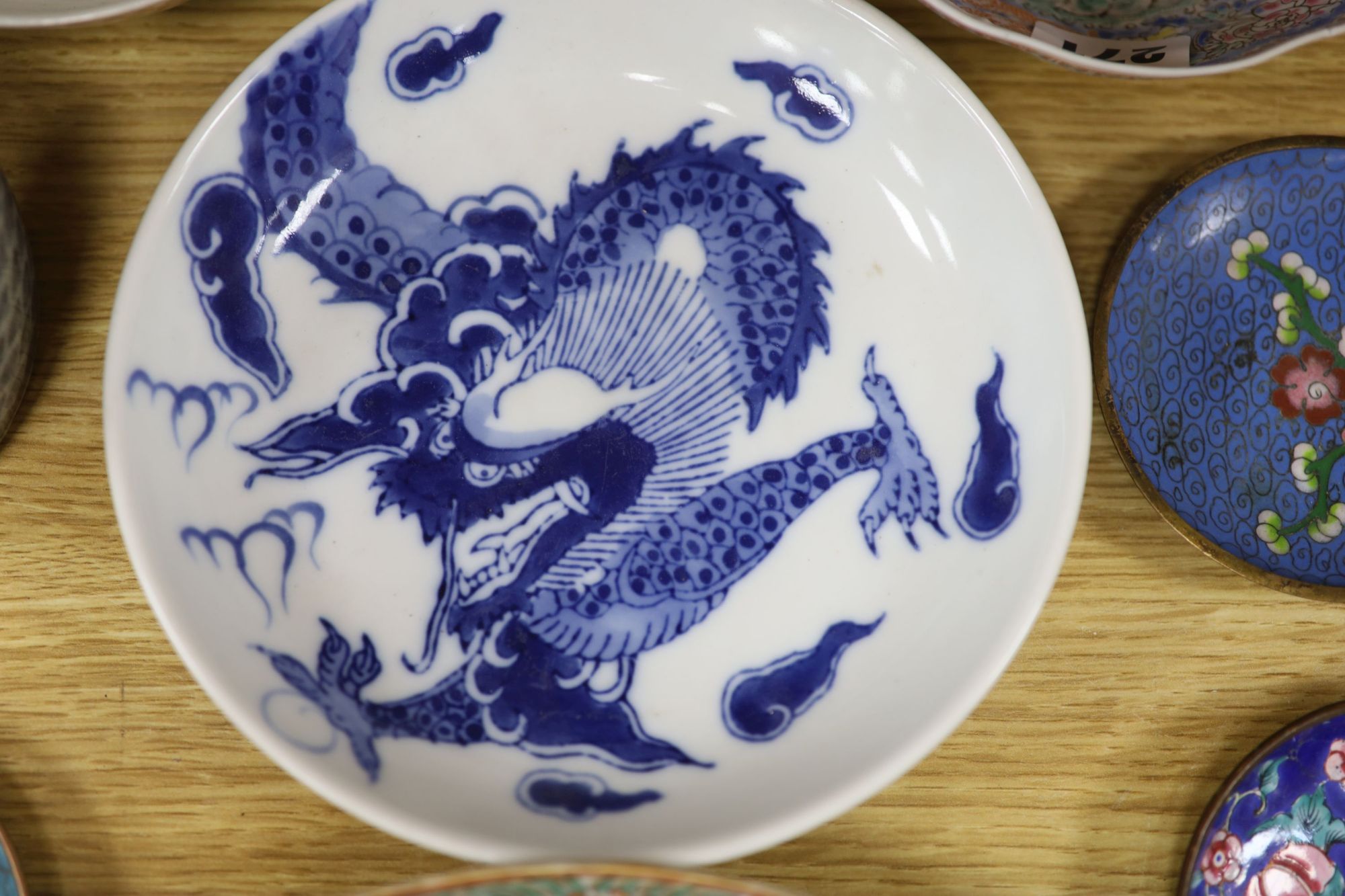 A quantity of Chinese and Japanese ceramics, including a blue and white dragon dish, a Cantonese famille rose dish, four cloisonne pi